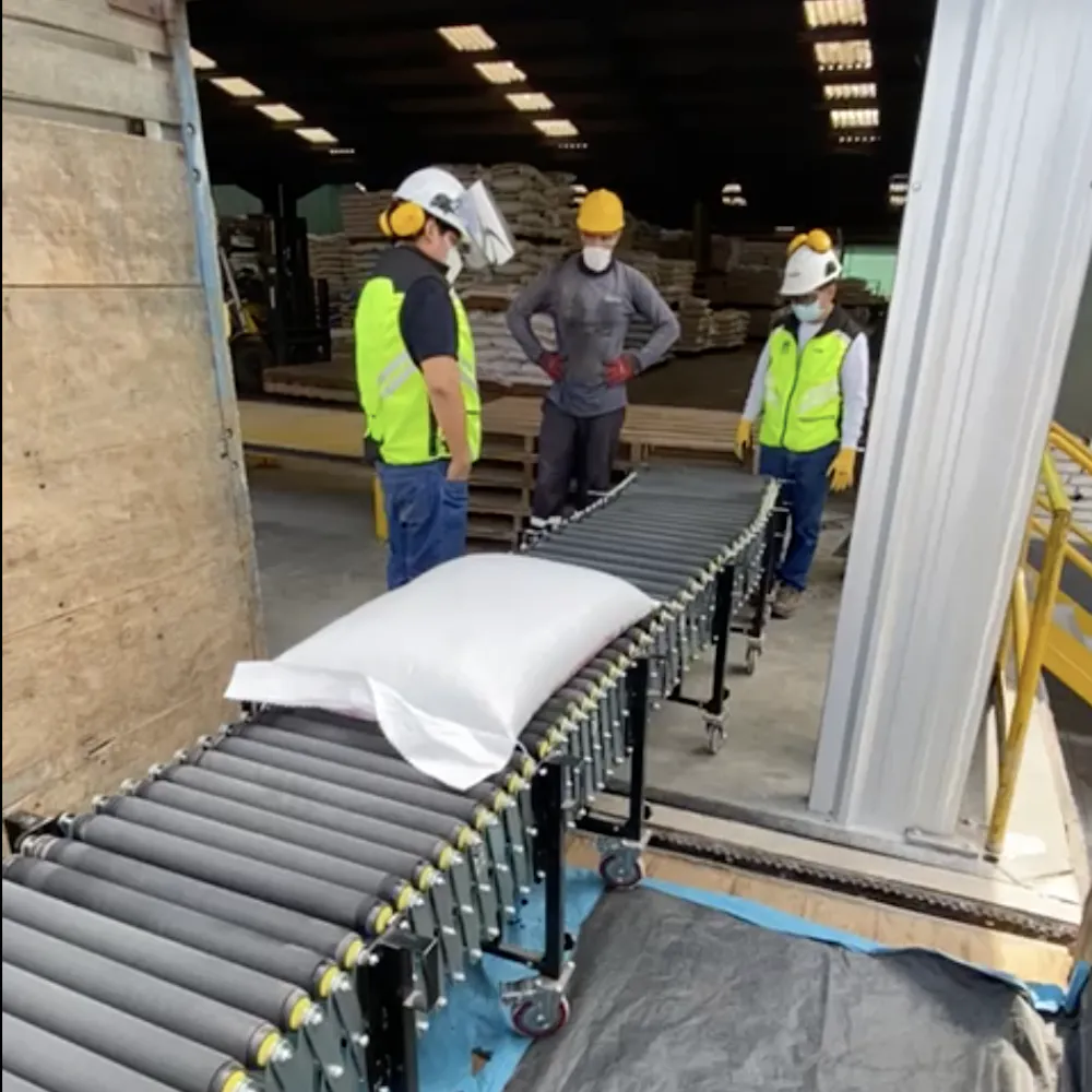 Flexible motorized roller conveyor for loading and unloading bags into trucks containers